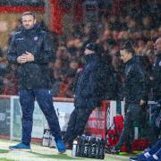 Ian Evatt at a rain-soaked Accrington last December - the kind of arena in which his side has not fared well under his stewardship.