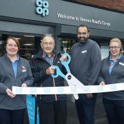 Staff at the Co-op and a customer at the unveiling of the refurbished store