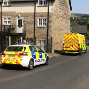 A police car and an ambulance outside an address on Square Street in Ramsbottom