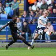 Bolton Wanderers' Kyle Dempsey crosses the ball despite the attentions of Peterborough United's Jeando Fuchs