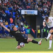 Bolton Wanderers' George Thomason shoots for goal despite the attentions of Peterborough United's Ben Thompson but it was blocked