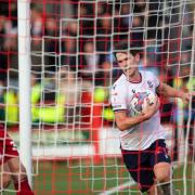 Kieran Lee grabs the ball after scoring Bolton's second goal at Accrington Stanley