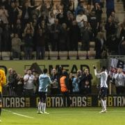 Wanderers' players salute the crowd after a 0-0 draw at Cambridge United