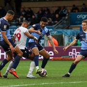 Bolton Wanderers' Victor Adeboyejo is tackled by Wycombe Wanderers Jordan Willis with Wycombe Wanderers' Chris Forino-Joseph Josh Scowen and David Wheeler close by