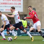 Bolton Wanderers' Kyle Dempsey runs with ball with Morecambe's Ashley Hunter close by