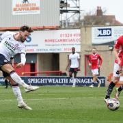 Bolton Wanderers' Josh Sheehan shoots for goal despite the attentions of Morecambe's Jacob Bedeau but it was saved