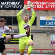 Bolton Wanderers' Conor Bradley cross is saved by Morecambe's Connor Ripley