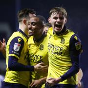 Victor Adeboyejo is congratulated by Gethin Jones and Conor Bradley after scoring against Sheffield Wednesday