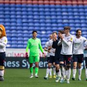 Bolton Wanderers players applaud fans at final whislte