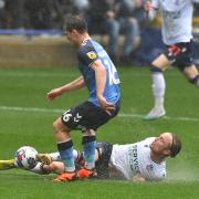 Bolton Wanderers' Kyle Dempsey battles with Fleetwood Town's Lewis Warrington