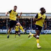 George Thomason and Dan Nlundulu celebrate a goal at Bristol Rovers