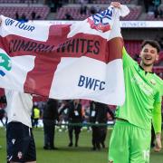 James Trafford holds a flag aloft after the Papa Johns Trophy win at Wembley