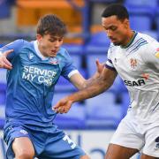 Josh Dacres-Cogley in action for Tranmere against Wanderers' Owen Beck last season