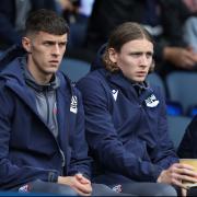 Eoin Toal and Jon Dadi Bodvarsson watch the Lincoln game from the sidelines
