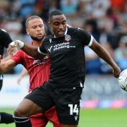 Victor Adeboyejo in action for Wanderers against Cheltenham's Charlie Kirk
