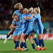 Toone celebrates with her England team-mates