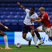 Bolton Wanderers' Cameron Jerome battles with Salford City's Theo Vassell