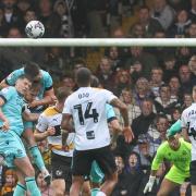 Will Forrester and Eoin Toal go up for a header in Saturday's 1-0 win at Port Vale