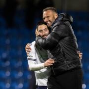 Ian Evatt hugs Josh Sheehan after the final whistle following the win at Wycombe