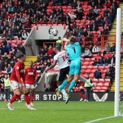 Victor Adeboyejo goes up for a header against Charlton's keeper