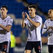Bolton Wanderers' Eoin Toal (left) , George Thomason and Josh Dacres-Cogley applaud their side's travelling supporters at the end of the match
