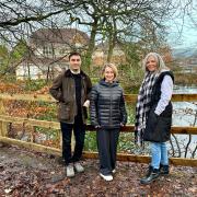 From left to right: Cllr Nadim Muslim,  Cllr Amy Cowen, and Cllr Samantha Connor with the new fencing around the fishing lodge