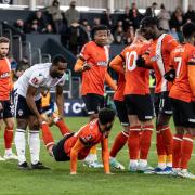Cameron Jerome shares a joke with Andros Townsend in the first game between Luton Town and Wanderers on January 7