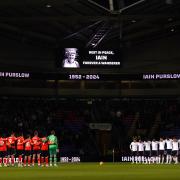 Bolton Wanderers and Luton Town players during a minute silence for Bolton Wanderers fan Iain Purslow who died on Saturday, ahead of the Emirates FA Cup third round replay match at the Toughsheet Community Stadium, Bolton. Picture date: Tuesday January