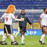 Victor Adeboyejo is congratulated by Lofty the Lion after Bolton's win against Cheltenham