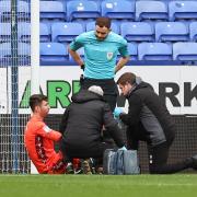 Nathan Baxter receives treatment on a wrist injury during the Barnsley game