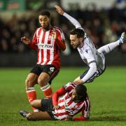 Bolton Wanderers' Josh Sheehan is fouled by Lincoln City's Timothy Eyoma with Ethan Erhahon close by