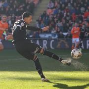 Josh Dacres-Cogley fires a shot at goal for Wanderers at Blackpool