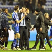 Bolton Wanderers manager Ian Evatt argues with Wigan Athletic's Charlie Goode at the end of the match
