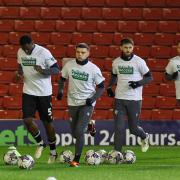 Wanderers players warm up before the game at Barnsley