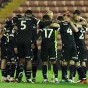 The Bolton squad in a huddle at Barnsley