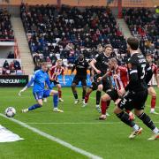 Jon Dadi Bodvarsson squeezes a shot narrowly wide of the Exeter goal