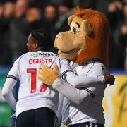 Nat Ogbeta hugs Lofty the Lion after opening the scoring against Oxford United