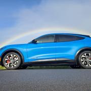 The Ford Mach-E pictured with a rainbow in the background in Kirklees