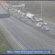 Traffic at standstill  and lane closed on busy M60 motorway after accident