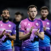 George Johnston applauds the travelling fans at Cambridge on Tuesday night.