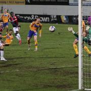 Arthur Gnahoua curls in a dramatic late winner for Wanderers in League Two on their last visit to Mansfield.