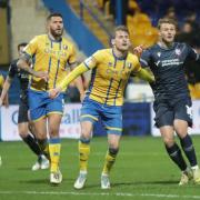 Sam Dalby wrestles with his marker in Wanderers' 1-0 win at Mansfield Town
