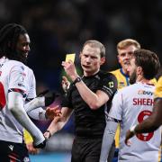 Bolton Wanderers' Ibrahim Cissoko is shown a yellow card by Referee Peter Wright for simulation