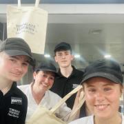 The team at Towngate Fisheries, showcasing the tote bags that will be on offer to customers on National Fish & Chip Day this Friday