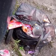 Black bags remained after residents say they were told excess waste would be collected