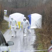 Forensic investigators in Ox Hey Lane, where a dead newborn baby was found by dog walkers