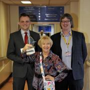Enid Dunn with her award after inventing special bags for breast cancer patients, she is pictured with, left, Sponsor Mark Cherry from GoToJobBoard and right, Sandy Wilkie from Bolton NHS Hospital