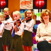 MP TUNES IN: Ruth Kelly with pupils from one of five Bolton schools who performed at the Bridgewater Hall in Manchester