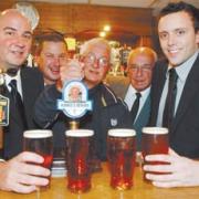 From left, Dave Robson, Steve Kay, Duncan Wright, Cres Robson and Max Flanigan raise a glass of Ronnie’s Reward