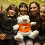 Markland Hill pupils, from left, Sammy Booth, Ella Cole, Aisha Natha, Natasha Bradley and Grace Barker with the iTeddy being raffled for Children in N
